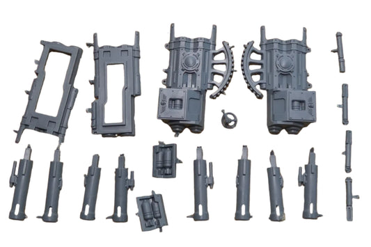Collection of gray plastic model parts on a textured surface